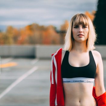 A person is walking down the street Description automatically generated